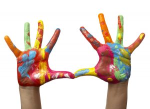 close up of child hands painted with watercolors, on white background with clipping path